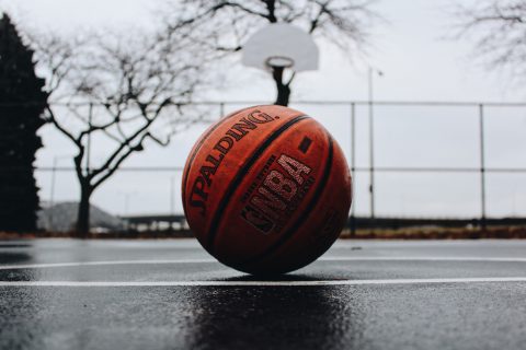 Basketball sitting on rainy basketball court